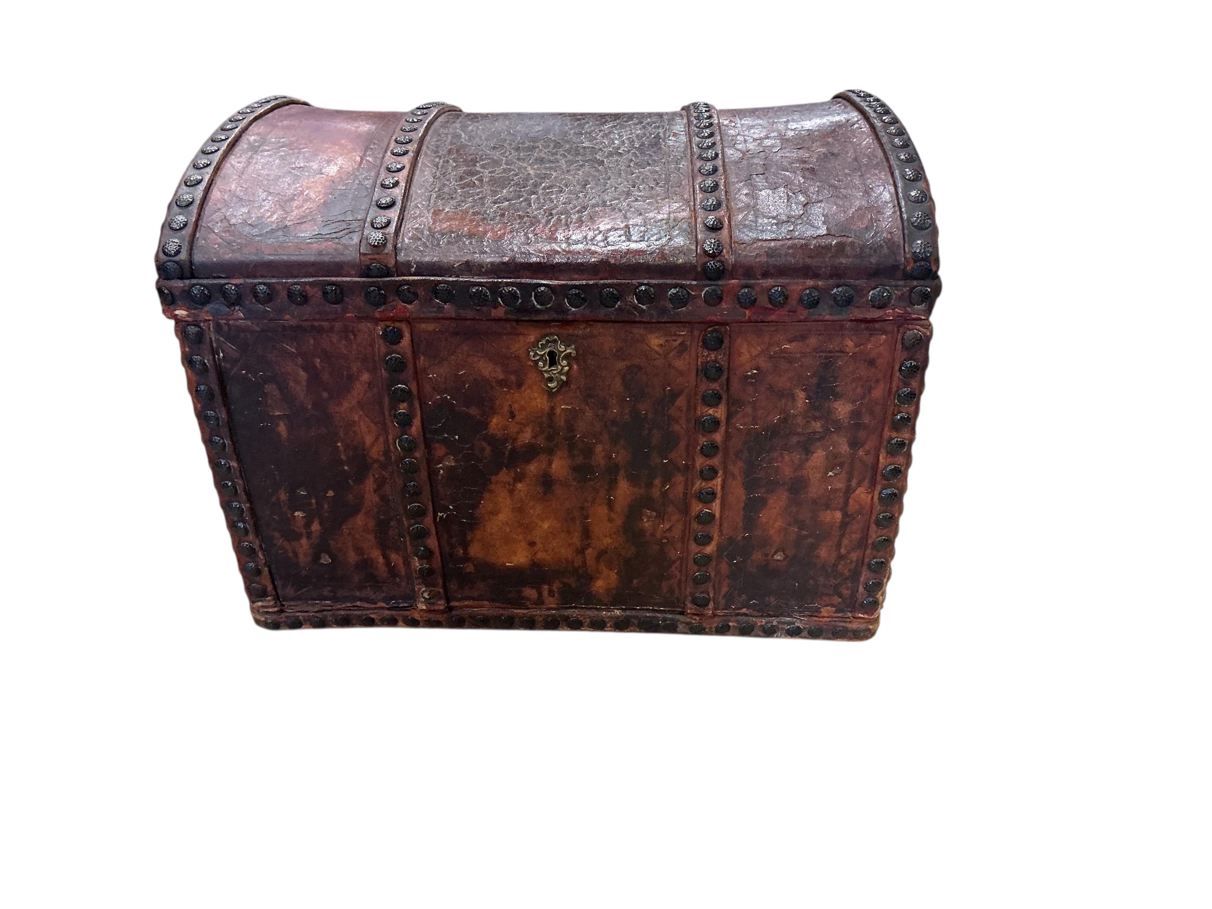 A small 18th century style studded domed top leather covered trunk with internal drawers, width 50cm, depth 35cm, height 37cm